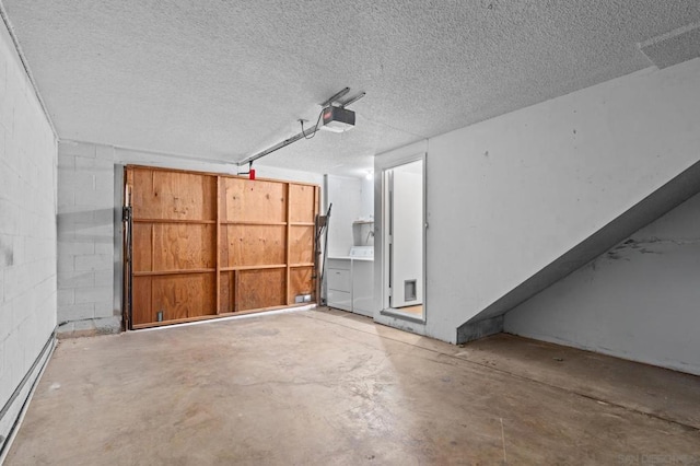 garage featuring a garage door opener and washer / dryer