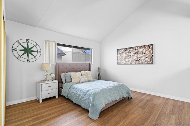 bedroom featuring vaulted ceiling and hardwood / wood-style floors