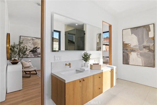 bathroom with a healthy amount of sunlight, vanity, and hardwood / wood-style flooring