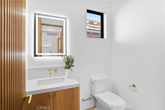 bathroom with toilet and vanity