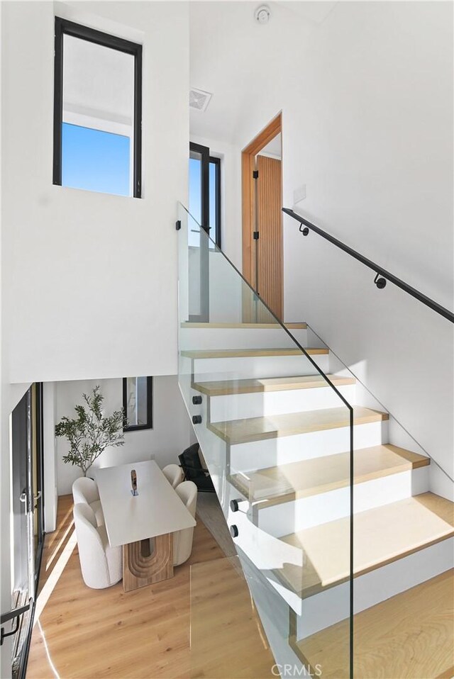 stairs featuring wood-type flooring