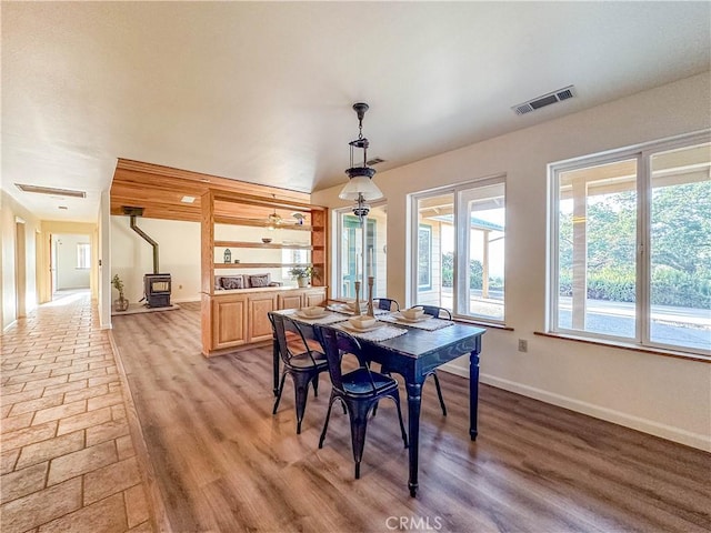 dining room featuring a wood stove and hardwood / wood-style floors