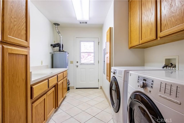 laundry area with cabinets, separate washer and dryer, sink, and light tile patterned flooring