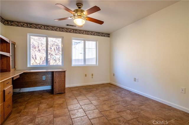 unfurnished office featuring ceiling fan