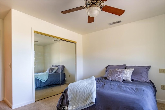 bedroom featuring ceiling fan, a closet, and carpet flooring