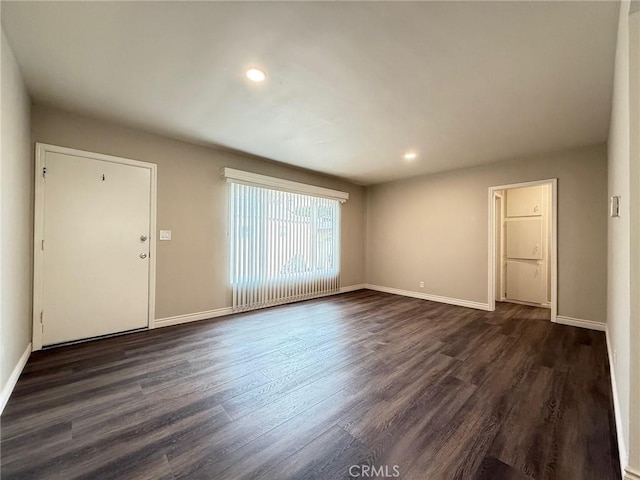 spare room with dark wood-type flooring