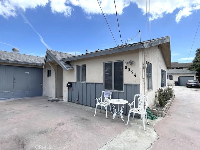 back of property featuring a patio area and a garage