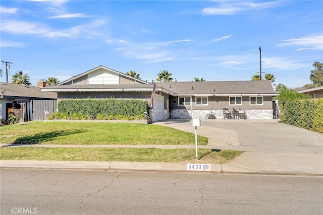 ranch-style home with a front yard and a garage