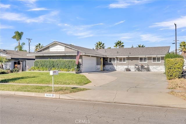 ranch-style home featuring a garage and a front yard