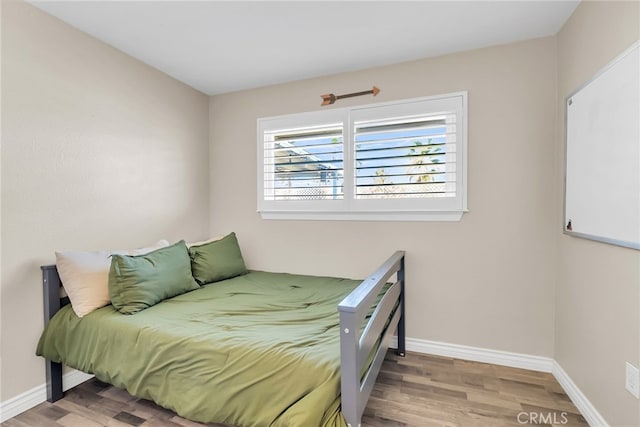 bedroom with hardwood / wood-style flooring