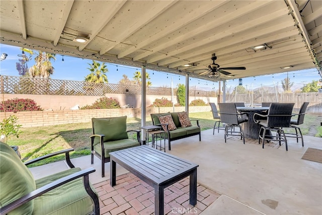 view of patio / terrace with ceiling fan and an outdoor living space