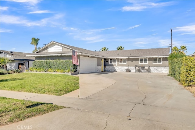 single story home with a front yard and a garage