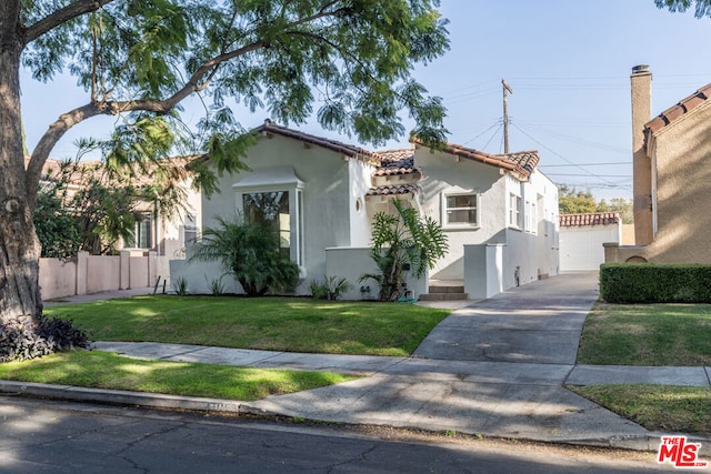 mediterranean / spanish-style home featuring a front lawn