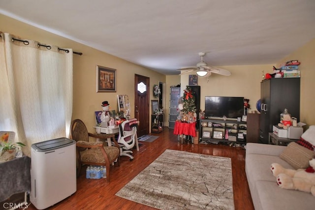 living room featuring ceiling fan and dark hardwood / wood-style flooring