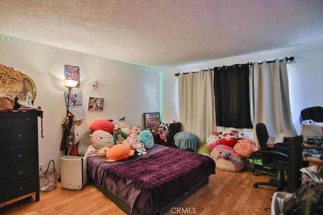 bedroom featuring a textured ceiling and light wood-type flooring