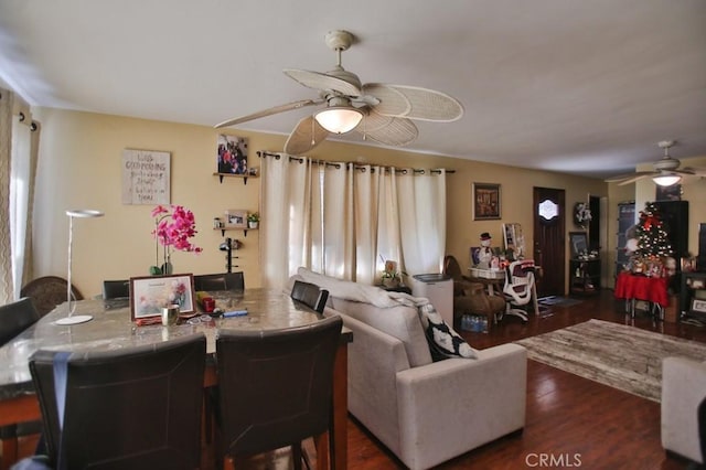 living room with ceiling fan and dark wood-type flooring