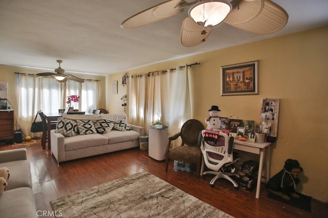 living room featuring ceiling fan and dark wood-type flooring