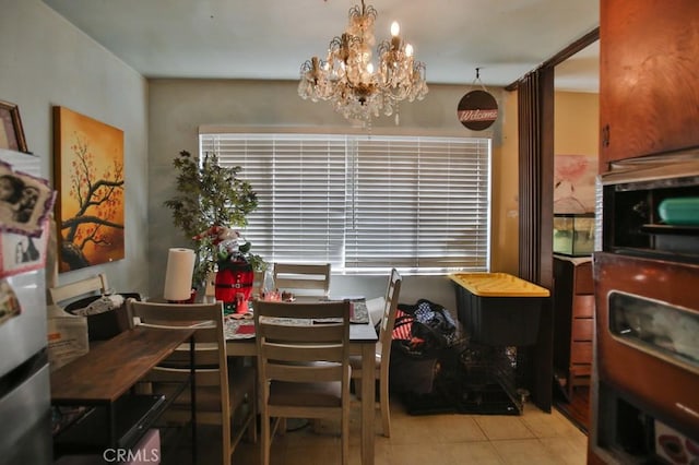 dining room with light tile patterned flooring and a chandelier