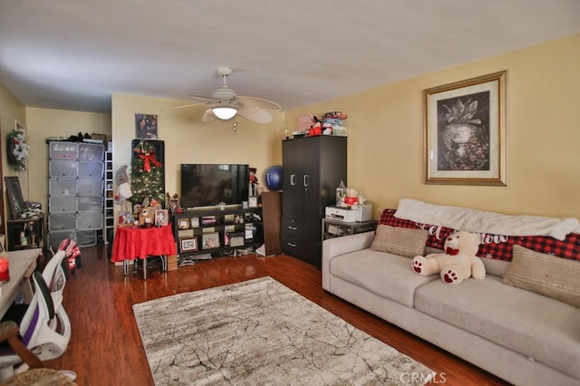 living room featuring ceiling fan and dark hardwood / wood-style floors