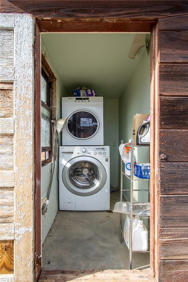 laundry area featuring stacked washing maching and dryer