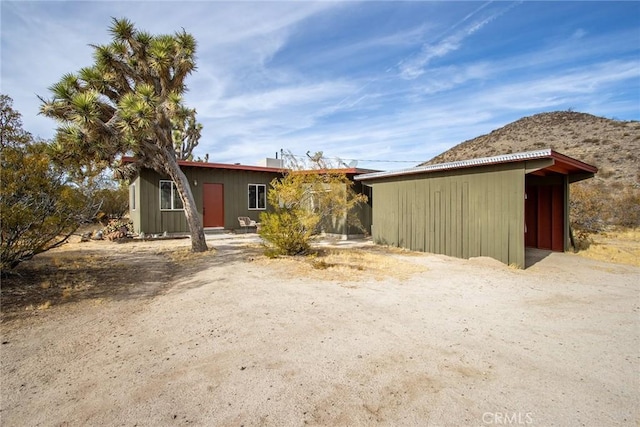 back of house featuring a mountain view