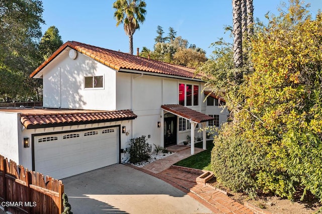 mediterranean / spanish-style home featuring a garage