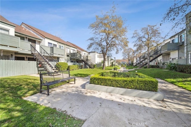 623 N Bristol St Unit 79, Santa Ana, CA 92703 - view of community featuring a residential view, a yard, fence, and stairs