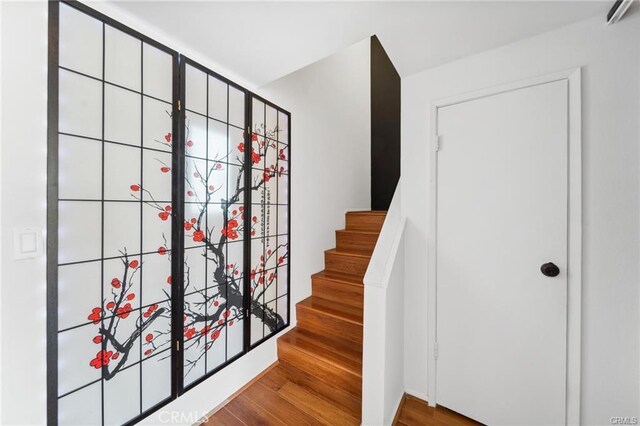623 N Bristol St Unit 79, Santa Ana, CA 92703 - staircase featuring wood finished floors