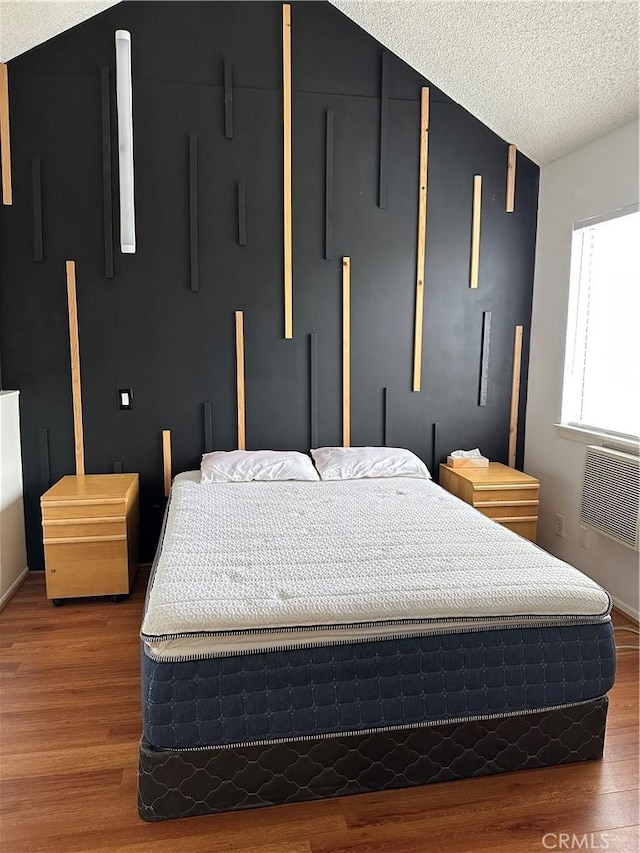 bedroom with dark wood-type flooring and a textured ceiling