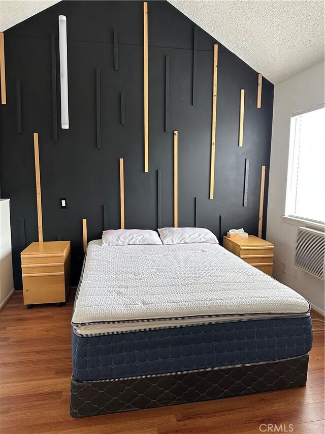 623 N Bristol St Unit 79, Santa Ana, CA 92703 - bedroom featuring vaulted ceiling, wood finished floors, and a textured ceiling