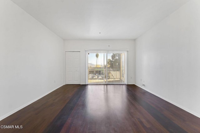 empty room with dark wood-type flooring