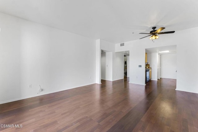 unfurnished room featuring dark wood-type flooring and ceiling fan