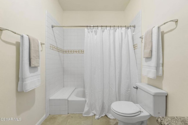 bathroom with tile patterned flooring, shower / tub combo, and toilet