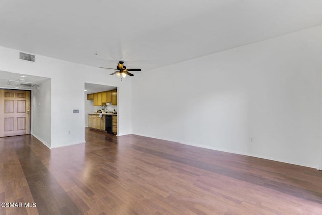 unfurnished living room featuring dark hardwood / wood-style floors and ceiling fan