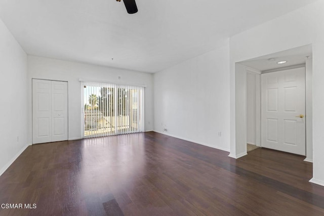 unfurnished room featuring ceiling fan and dark hardwood / wood-style floors