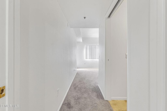 corridor featuring light carpet