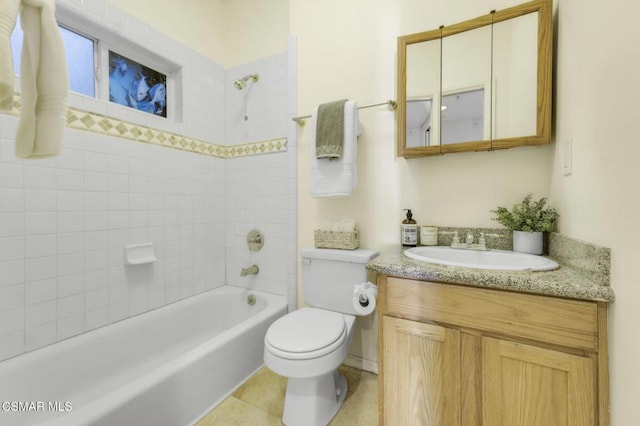 full bathroom with vanity, tiled shower / bath, tile patterned flooring, and toilet