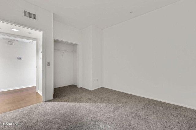 unfurnished bedroom featuring carpet and a closet