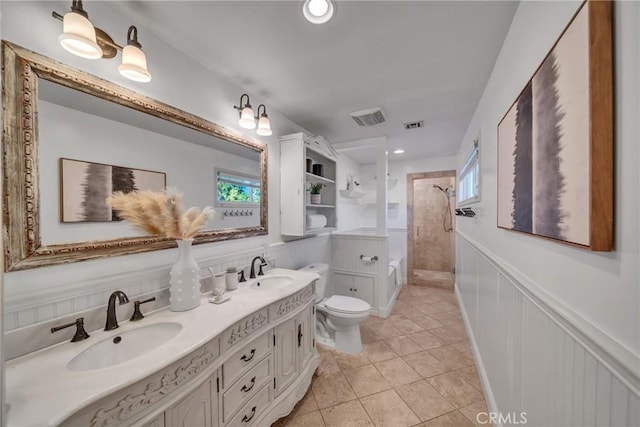 bathroom featuring tile patterned floors, toilet, walk in shower, and vanity