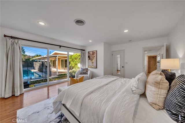 bedroom with hardwood / wood-style flooring and access to outside