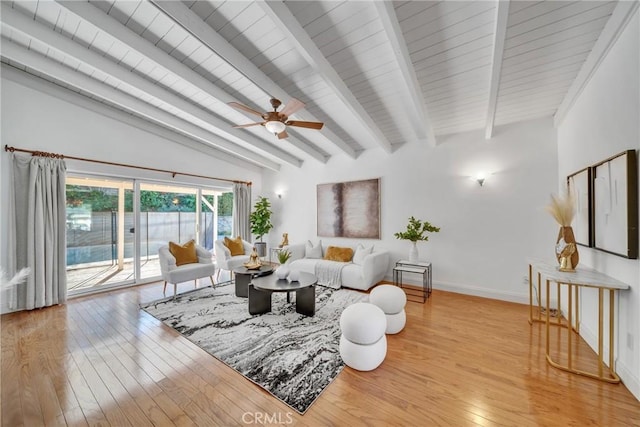 living room featuring ceiling fan, lofted ceiling with beams, and light wood-type flooring