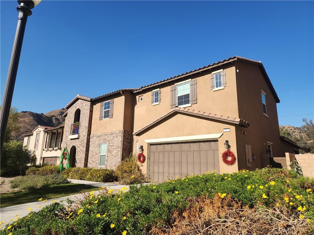 mediterranean / spanish-style home with a garage