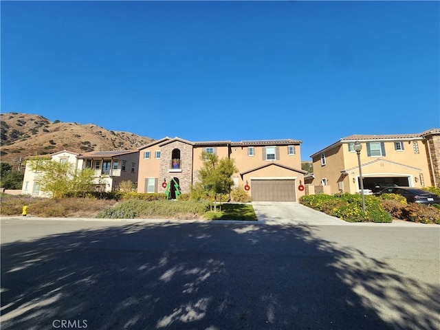 view of front of house with a garage and a mountain view