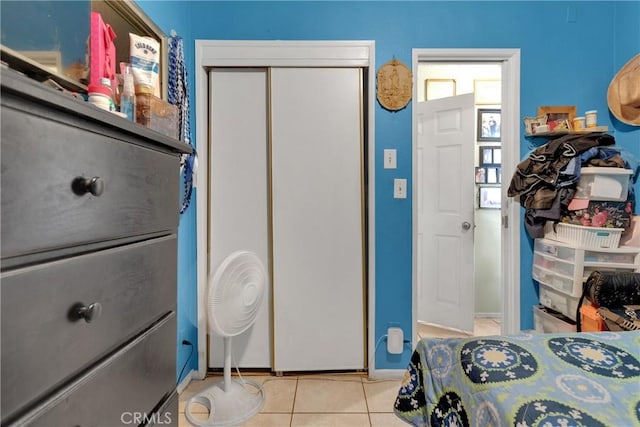 tiled bedroom featuring a closet