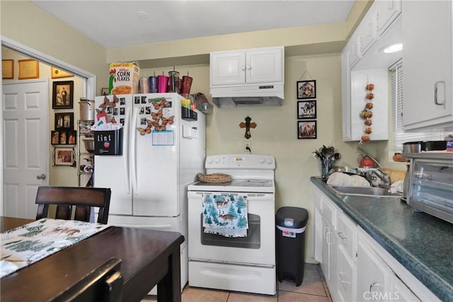 kitchen featuring white cabinets, sink, light tile patterned flooring, and white appliances