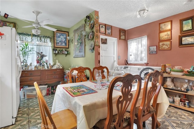 dining area with ceiling fan and a textured ceiling