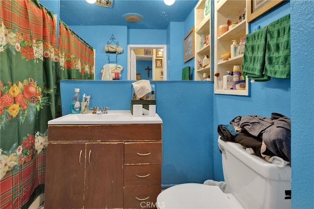 bathroom with toilet and vanity