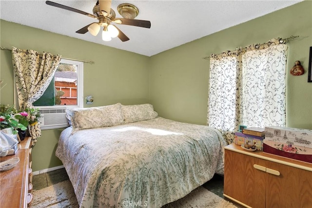 bedroom with ceiling fan and cooling unit