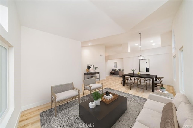 living room with wood-type flooring and lofted ceiling