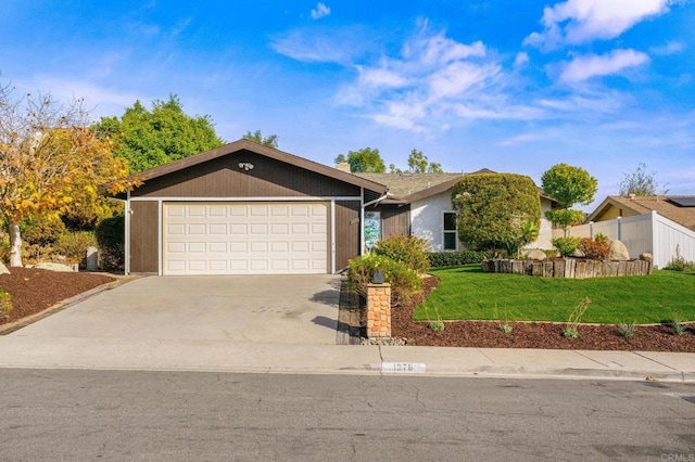 ranch-style house featuring a garage and a front yard